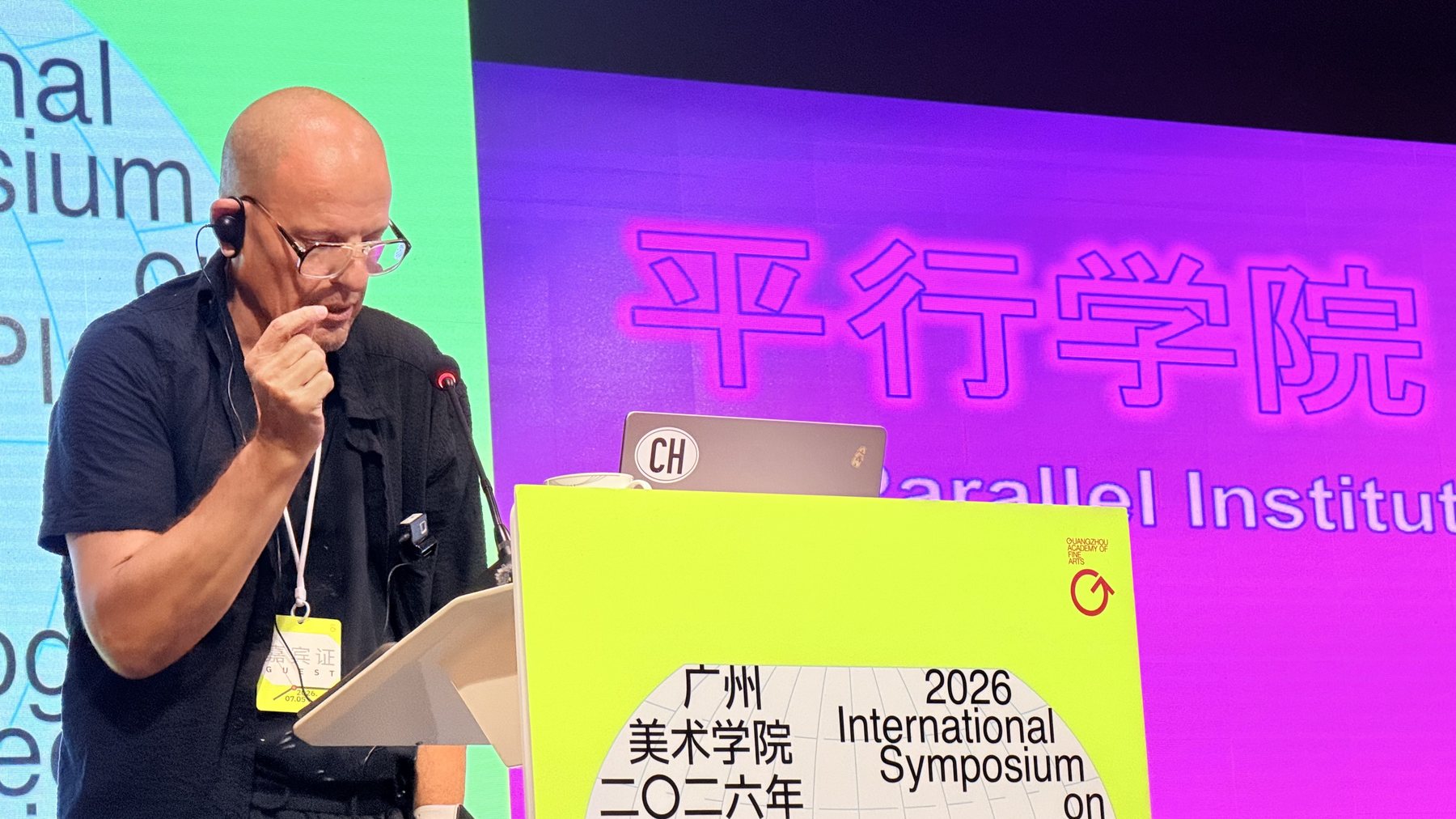 Luzius Bernhard delivering the Orchestration keynote, GAFA 2026, with the Parallel Institute slide behind him